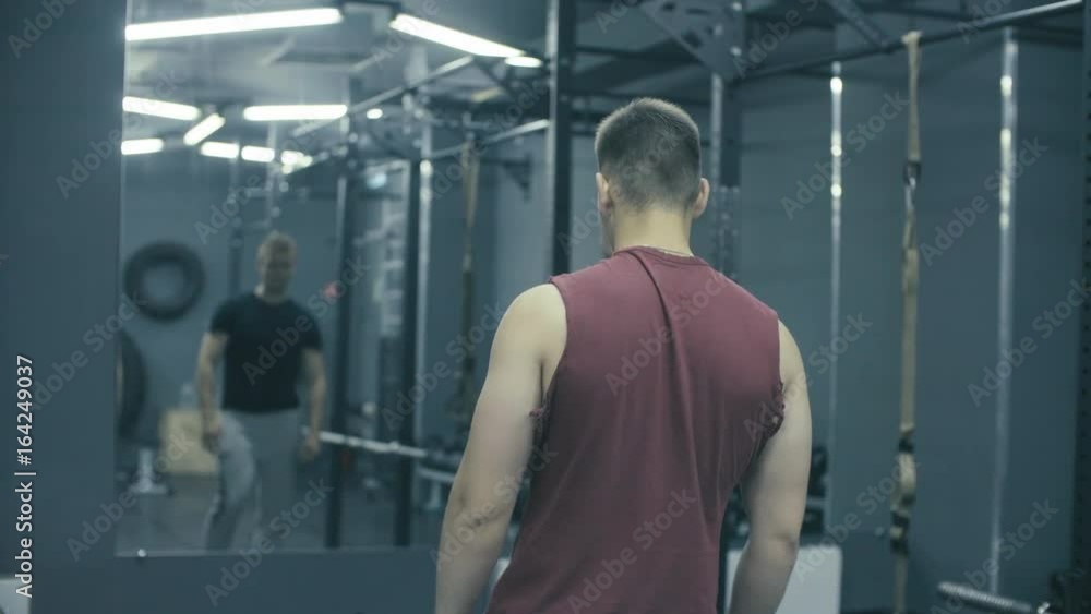 Two men training in a fitness studio Two men training in a fitness studio