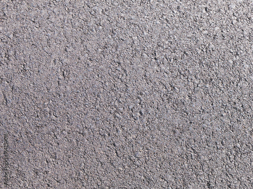 The texture of the surface of the asphalt road for use as a background. Consists of fine gravel and resin.