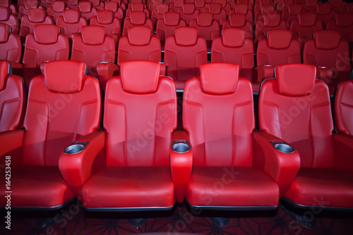 Red seat in the movie theater. Blurry background.