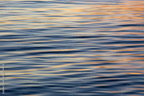 Beautiful sunset reflections on a silky, reflective water surface.