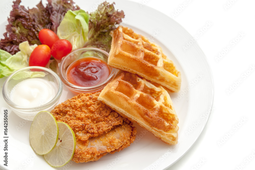 Crispy fried chicken serve with waffle, vegetable and sauces