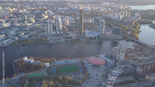 Aerial view city and sports palace. Modern city in sunset, aerial view of cityscape. Urban landscape photo