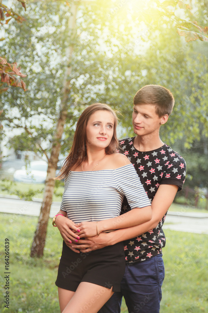 Fototapeta premium boyfriend hugging his girlfriend from behind