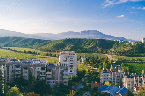 A beautiful landscape of mountains at dawn. Residential buildings