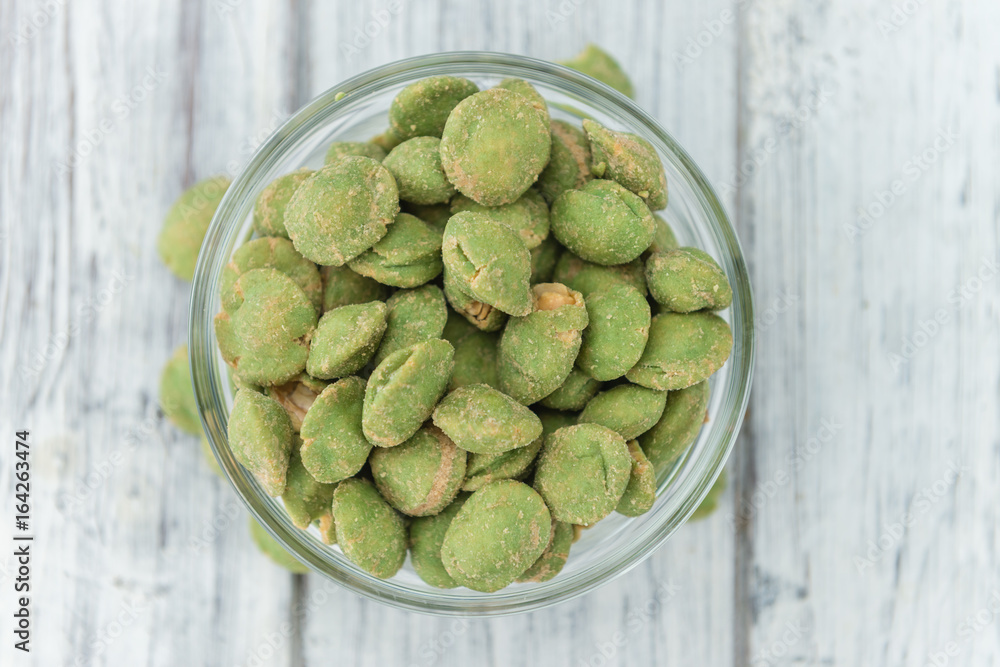 Portion of Wasabi coated Peanuts on wooden background (selective focus) Portion of Wasabi coated Peanuts on wooden background (selective focus)