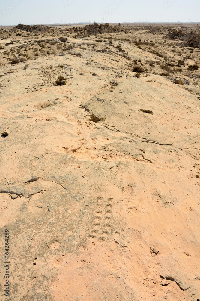 Rock outcrop with ancient dot carvings in Jebel Jassassiyeh in Northern Qatar. Rock outcrop with ancient dot carvings in Jebel Jassassiyeh in Northern Qatar.
