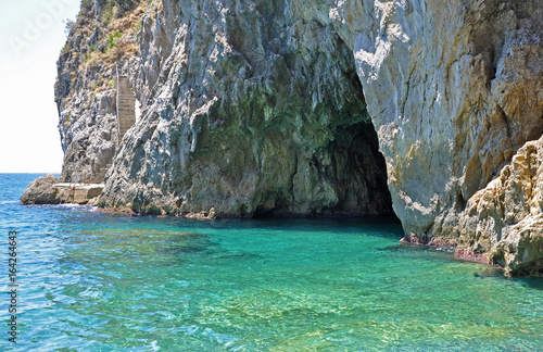 Entrance to the Green grotto with colourful walls and emerald water