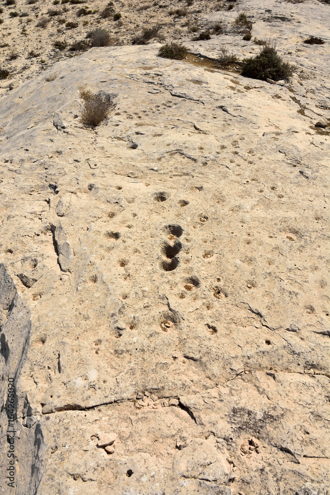 Rocky deserted landscape with ancient dot carvings at Jebel Jassassiyeh site in Northern Qatar. Rocky deserted landscape with ancient dot carvings at Jebel Jassassiyeh site in Northern Qatar.
