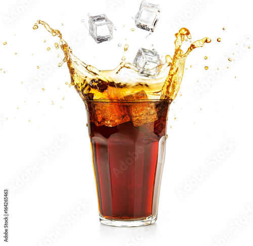 ice cubes falling into a cola drink splashing 