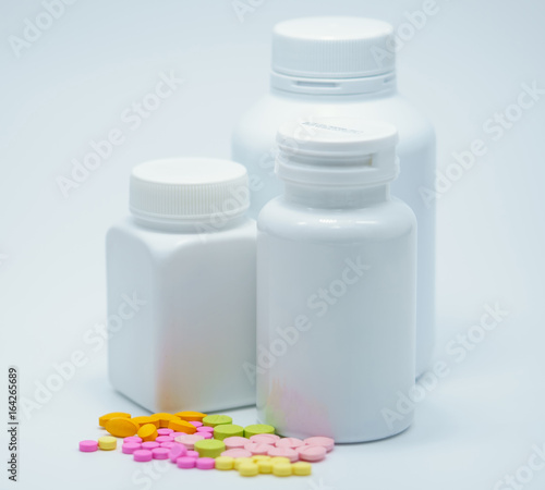 Capsule pills with bottles on white background