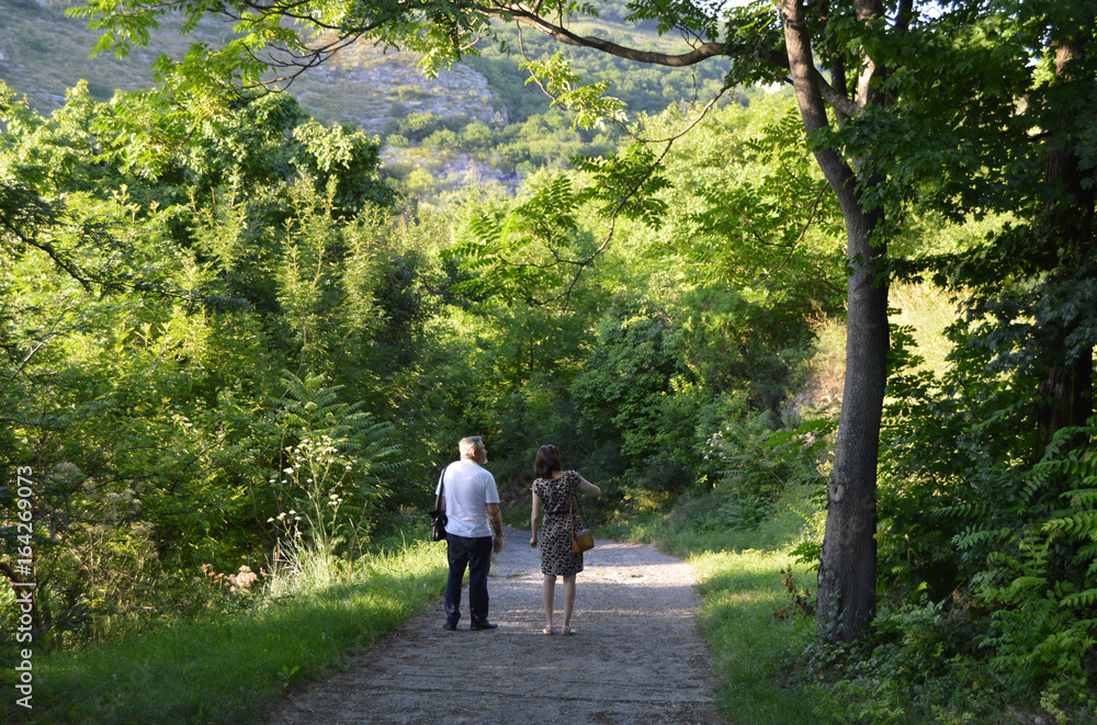 A couple of adults walking in summer