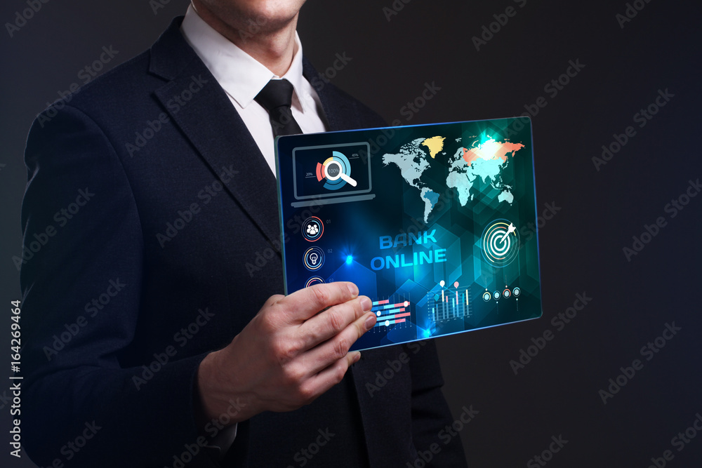 Business, Technology, Internet and network concept. Young businessman working on a virtual screen of the future and sees the inscription: Bank online Business, Technology, Internet and network concept. Young businessman working on a virtual screen of the future and sees the inscription: Bank online