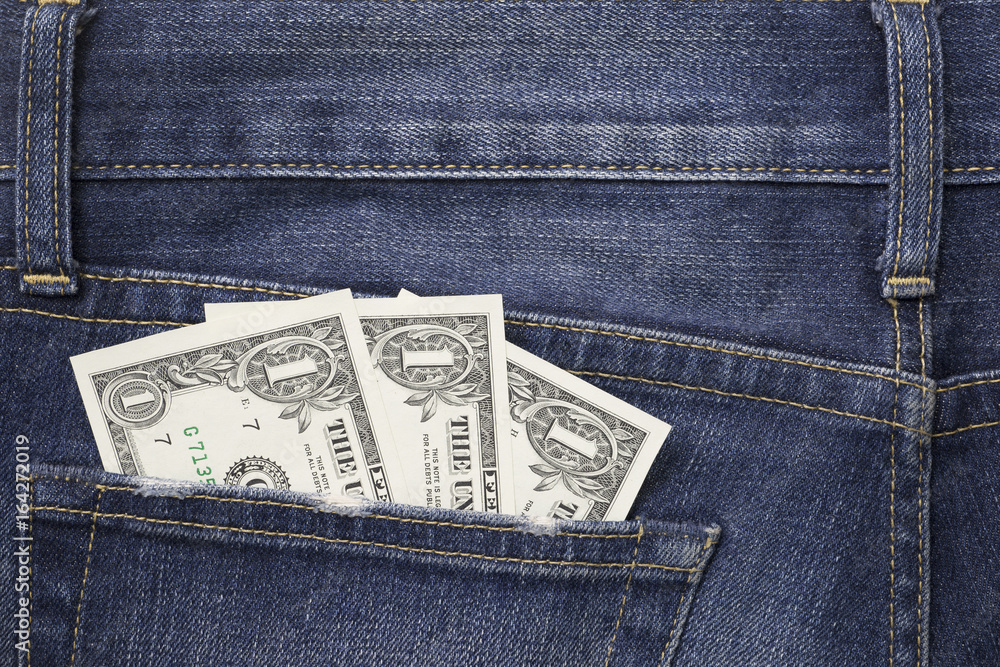 Some dollars in a pocket of jeans Some dollars in a pocket of jeans