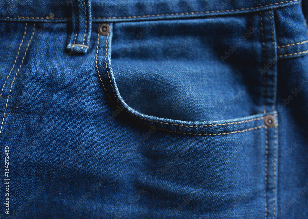 Texture of a denim jeans cloth pants with pocket Texture of a denim jeans cloth pants with pocket