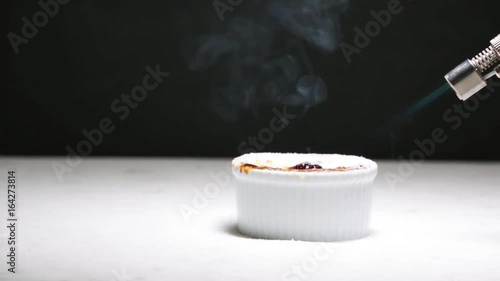 Chocolate creme brulee being caramalized from sugar to crust, with a kitchen torch, fast forward (2x speed) photo