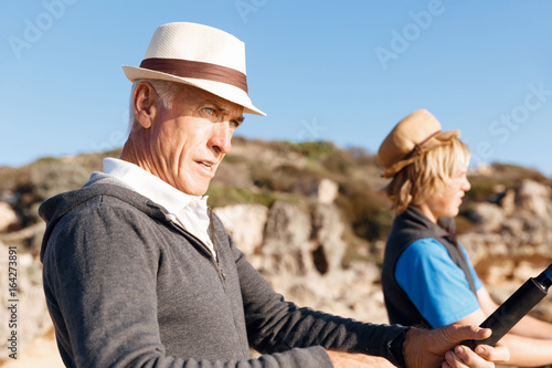 Senior man fishing with his grandson