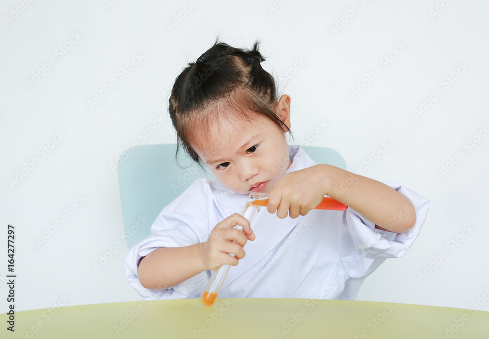 Asian child in scientist uniform holding test tube with liquid, Scientist chemistry and science education concept.