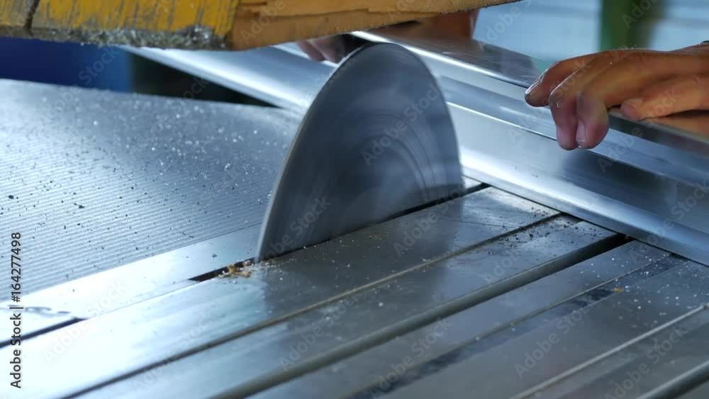Circular saw cutting through stainless steel in a metal factory
Circular saw cutting through stainless steel in a metal factory