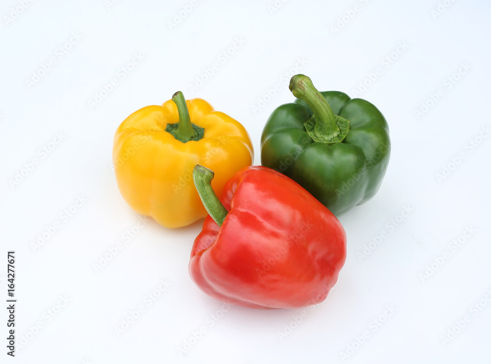 Green, red and yellow bell pepper isolated on white background. Green, red and yellow bell pepper isolated on white background.
