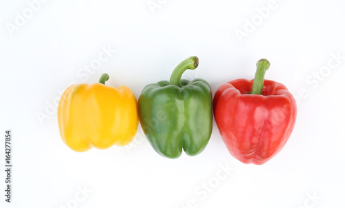 Green, red and yellow bell pepper isolated on white background.