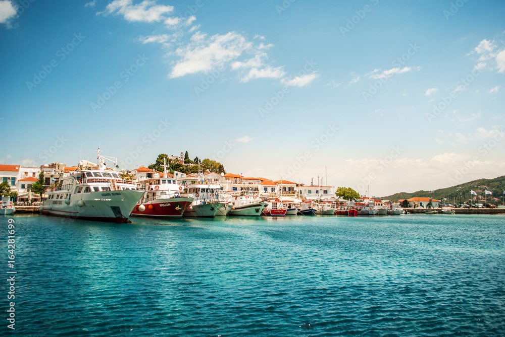 Skiathos, Greece - June 27, 2011: Beautiful turquoise blue sea on the island of Skiathos with boats and yachts in the background