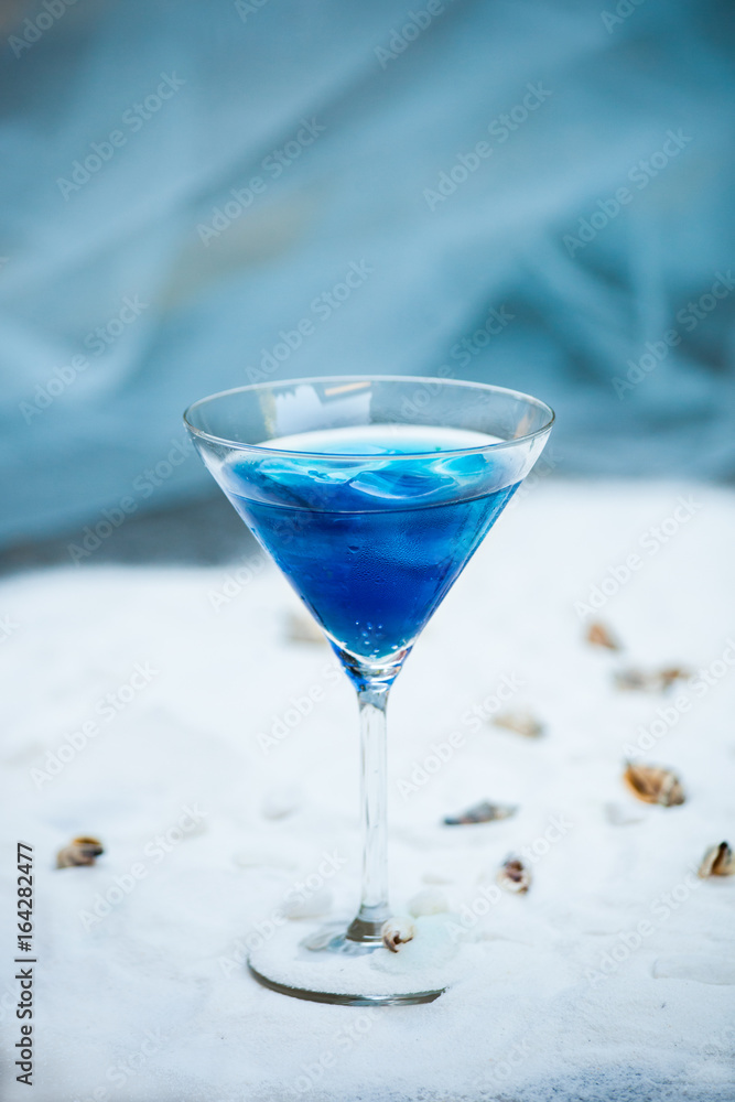 blue cool refreshing summer cocktail drink with ice  in glass
