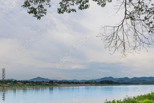 Mekong River between Lao PDR and Chiang Khan district, Loei province, the beautiful sky, cloud, and the branches of trees.