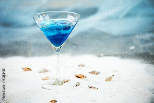 blue cool refreshing summer cocktail drink with ice  in glass photo
