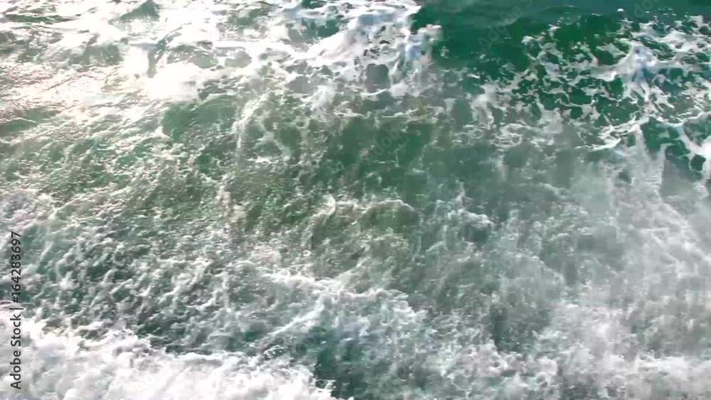Blue-green waves on the surface of the ocean. Top view of the water. Blue-green waves on the surface of the ocean. Top view of the water.