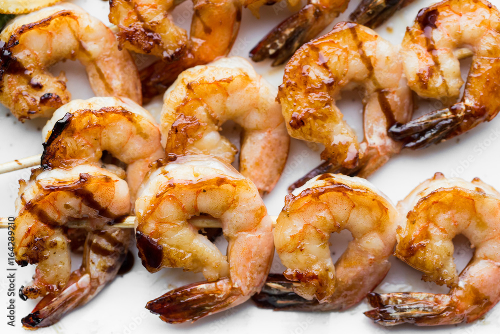 tasty spiced shrimp skewers on a barbecue tasty spiced shrimp skewers on a barbecue