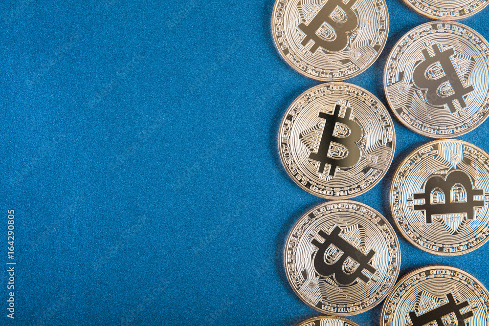 Golden Bitcoins (digital virtual money) on blue background.