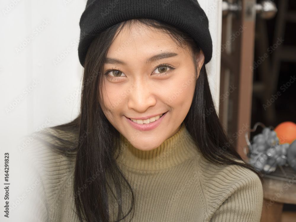 Autumn portrait of pretty woman indoor smiling happy in hat and scarf. Autumn portrait of pretty woman indoor smiling happy in hat and scarf.