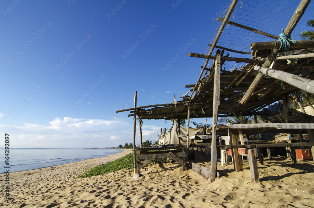 tropical sea view under wooden hut at sunny day. sandy beach and blue sky. soft cloud and island background