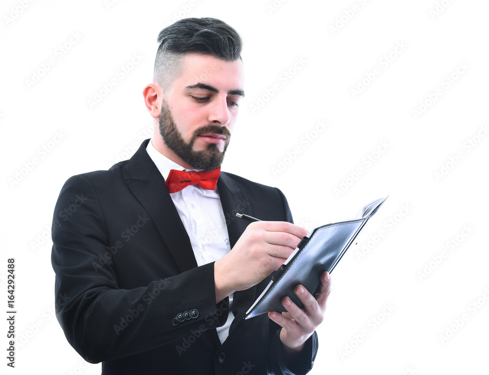 Bearded businessman with moustache and smile holds organizer and writes Bearded businessman with moustache and smile holds organizer and writes