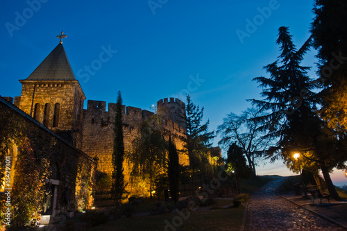 Cobblestone path along Kalemegdan fortress churches, towers and walls at blue hour in Belgrade, Serbia