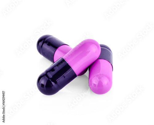 Purple pill capsule isolated on white background