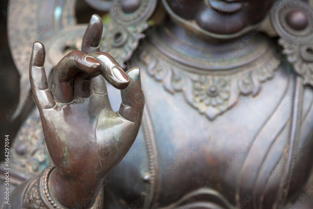 Detail of Buddha statue with Karana mudra hand position