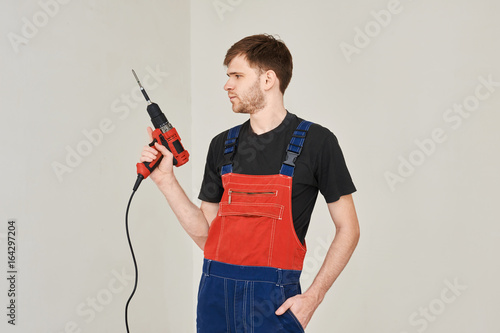 Wire electric screwdriver in hand