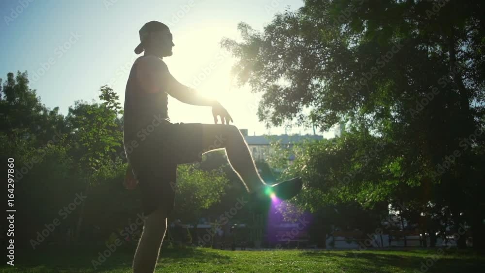 silhouette man do knee rotation exercises sunny green meadow rapid slow motion silhouette man do knee rotation exercises sunny green meadow rapid slow motion