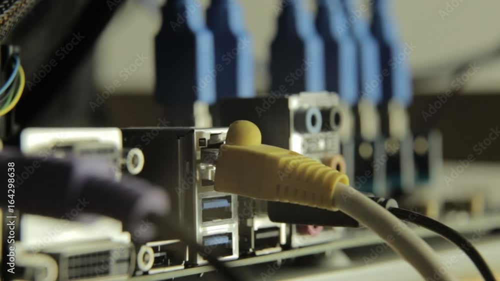 Network card with cable in motherboard with razer on a background. Flashing lamp, signal presence Network card with cable in motherboard with razer on a background. Flashing lamp, signal presence