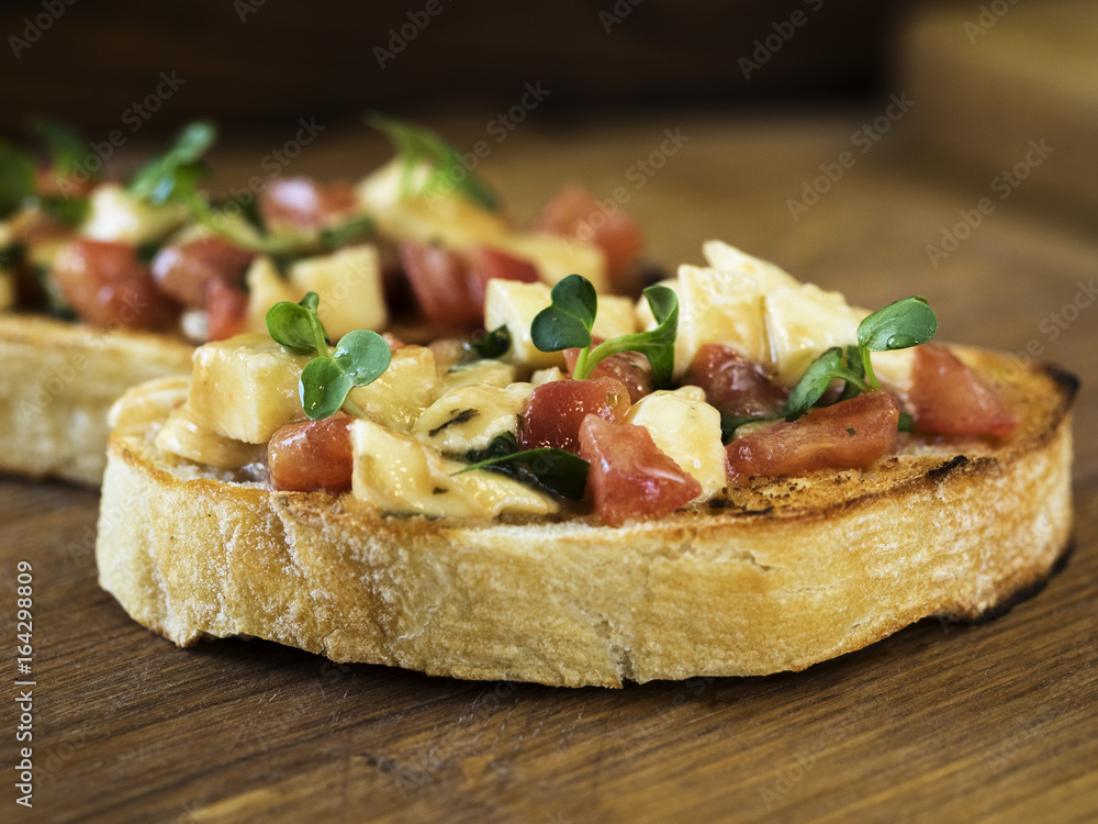 Bruschetta with mozzarella and tomatoes Bruschetta with mozzarella and tomatoes