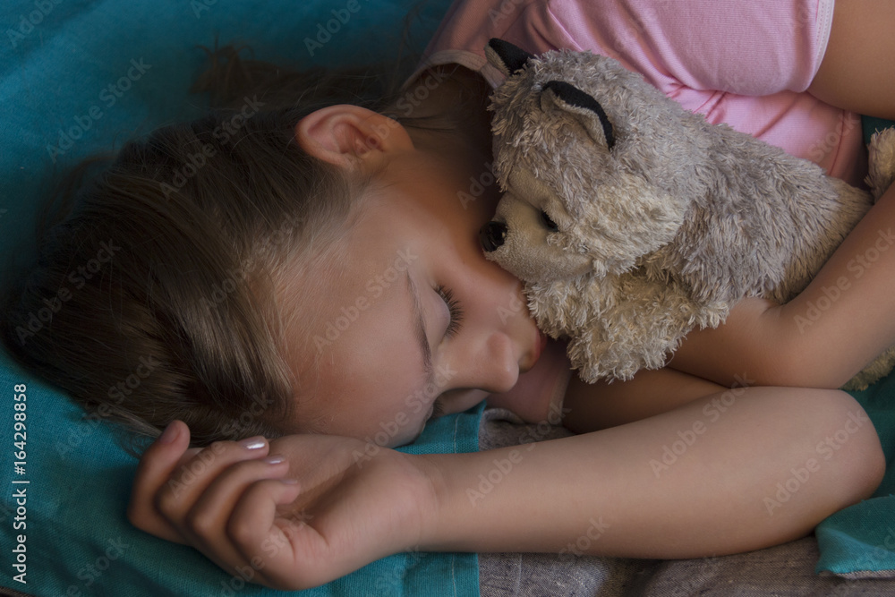 Little blond child sleeping in his bed with toy. Little blond child sleeping in his bed with toy.