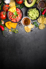 Latinamerican food party sauce guacamole, salsa, chips and tequi