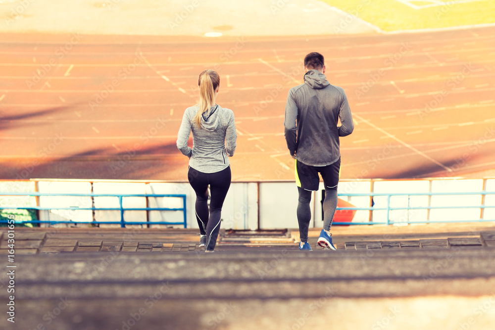 couple running downstairs on stadium couple running downstairs on stadium