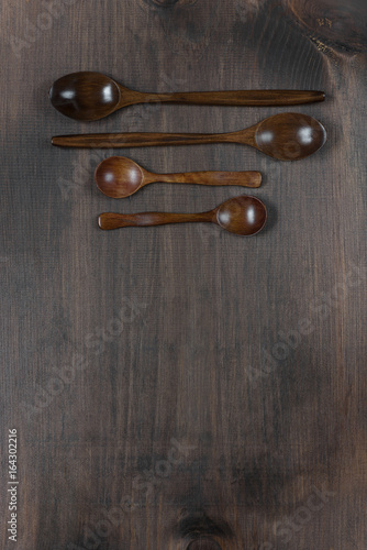 Wooden spoons on a dark woo...