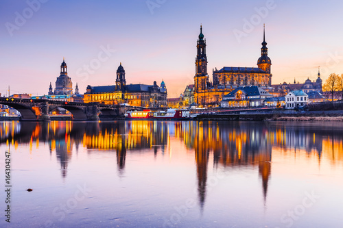 Dresden, Germany. Cathedral of the Holy Trinity or Hofkirche, Bruehl's Terrace. Twilight sunset on Elbe river in Saxony.