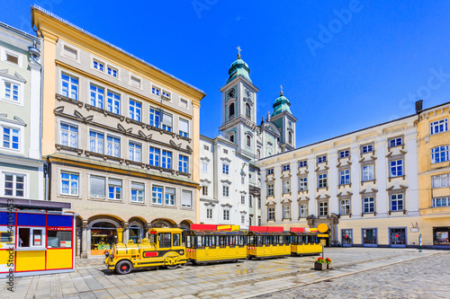 Linz, Austria. Old Cathedral (Alter Dom) and tourist train in the Main Square (Hauptplatz) photo