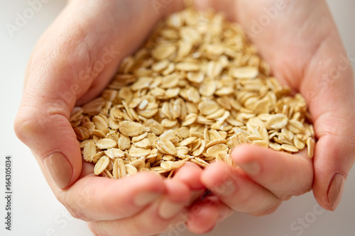 close up of hands holding oat flakes © Syda Productions
