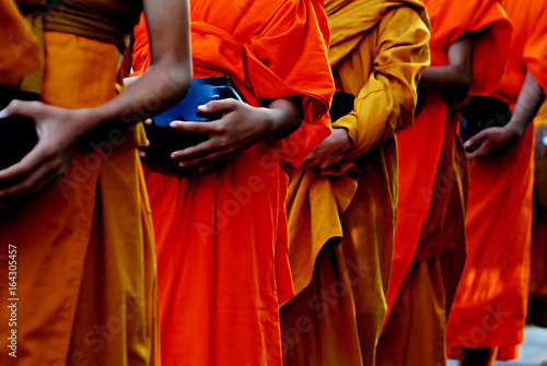 Buddhist Lent concept using : Monks in robes collecting alms picture
