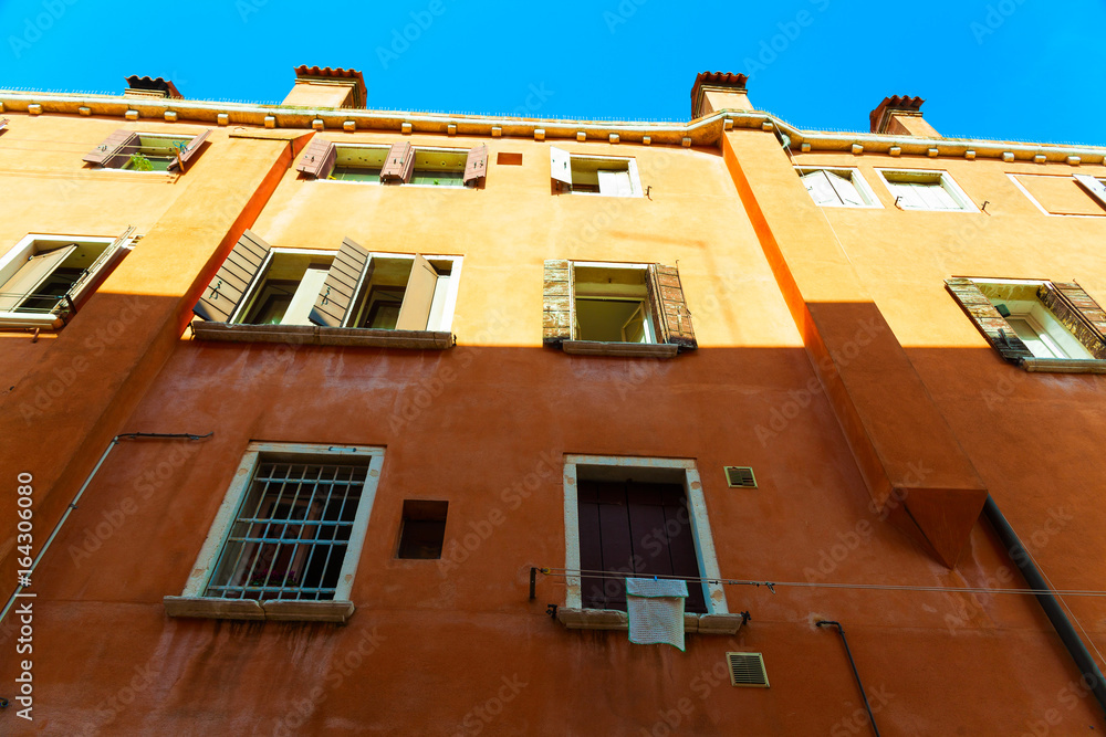 The facade of a house in Venice with windows